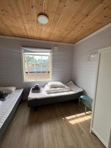 a room with two beds and a window at Koselig hus i havna in Svolvær