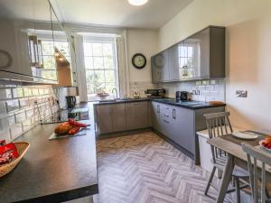 a kitchen with a table and a counter top at The Garden Apartment in Yarm