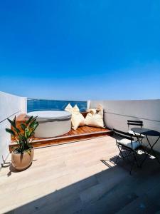 a balcony with a tub and a table and chairs at Palazzo Matà Boutique Hotel in Taranto