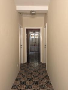 an empty hallway with a door in a building at Nadalina Guest House in Kotor