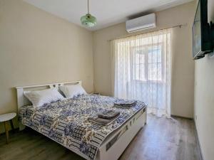 a bedroom with a bed and a window at Nadalina Guest House in Kotor