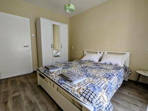 a bedroom with a bed with a comforter on it at Nadalina Guest House in Kotor