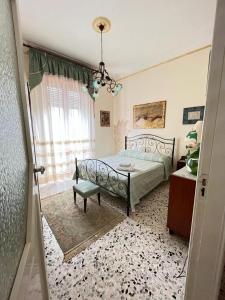 a bedroom with a bed and a chandelier at Casa vacanze "I due parchi" in Calatabiano