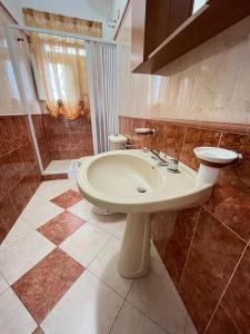 a bathroom with a sink and a shower and a toilet at Casa vacanze "I due parchi" in Calatabiano