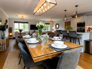 a dining room and living room with a table and chairs at Polished Pebble in Beadnell