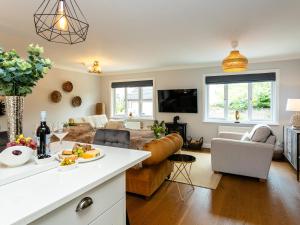 a living room with a couch and a table at Polished Pebble in Beadnell