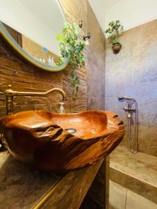 a wooden sink in a bathroom with a mirror at D & J Luxury House in Nea Kalikratia