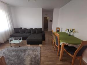 a living room with a couch and a table at Old Town Apartment 2 bedrooms, 1 living in Baia Mare