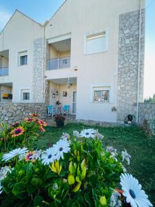 a house with flowers in front of it at D & J Luxury House in Nea Kalikratia