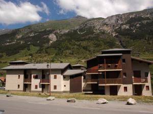 a building on the side of a road with a mountain at Appartement Lanslevillard, 2 pièces, 4 personnes - FR-1-508-231 in Lanslebourg-Mont-Cenis