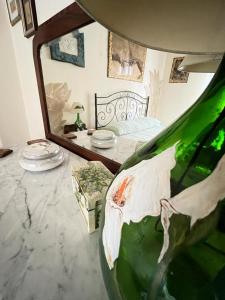 1 dormitorio con cama con espejo y mesa en Casa vacanze "I due parchi", en Calatabiano