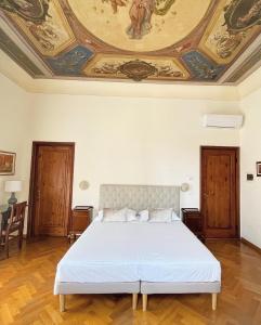 a bedroom with a bed with a painting on the ceiling at Cimabue 9 in Florence