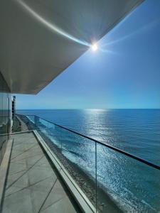 a view of the ocean from the balcony of a building at Apartment Batumi Weekend in Batumi