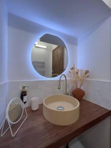 a bathroom with a sink and a mirror at Bormes - Le Loft in Bormes-les-Mimosas