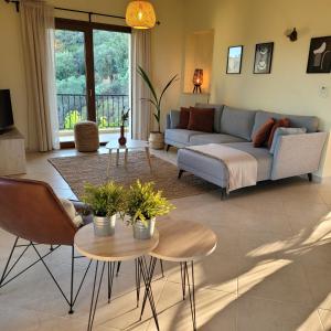 a living room with a couch and a table at Villa Farangi in Gállos