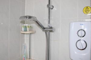a shower with a faucet in a bathroom at Coventry Cosy Home - Great location for Contractors, Families, Relocators, close Walsgrave Hospital and Motorways in Wyken