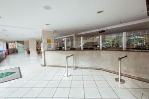 a lobby with a counter in a building at Thermas Paradise Rio Quente Flats 332 in Rio Quente