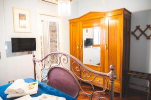 a room with a chair and a wooden cabinet at Casa Tonina in Carloforte