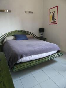 a bedroom with a bed with a metal frame at Maison familiale près de la mer in Argelès-sur-Mer +24 photos