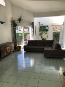a living room with a couch and a fireplace at Maison familiale près de la mer in Argelès-sur-Mer