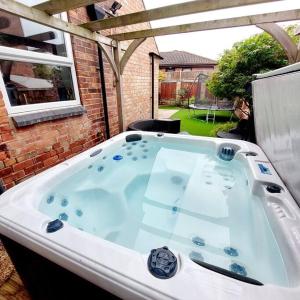 a jacuzzi tub in the backyard of a house at 3 bed Luxury Victorian Home with Hot Tub in Nottingham
