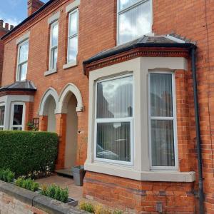 a brick house with a window on the side of it at 3 bed Luxury Victorian Home with Hot Tub in Nottingham