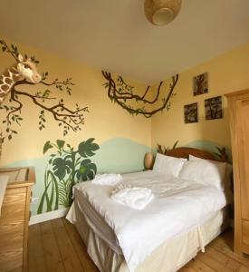 a bedroom with a bed with a giraffe mural on the wall at 3 bed Luxury Victorian Home with Hot Tub in Nottingham