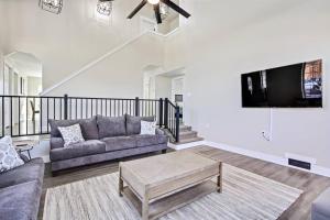 ein Wohnzimmer mit einem Sofa und einem TV in der Unterkunft Modernized Picturesque Lonestar Property with Priv in Nampa