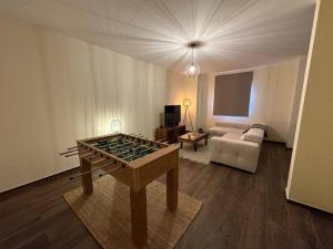 a living room with a foosball table and a couch at Casa da Portelinha in Castelo de Paiva