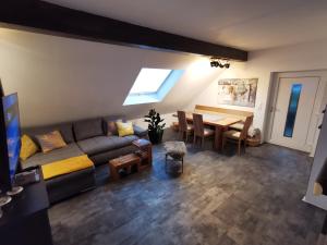 多恩比恩的住宿－Skyline klimatisierte Dachgeschoss-Wohnung in Dornbirn mit Blick ins Rheintal，客厅配有沙发和桌子