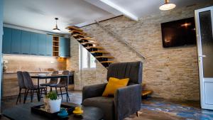 uma sala de estar com uma escada e uma mesa e cadeiras em Family House Bjelila em Tivat