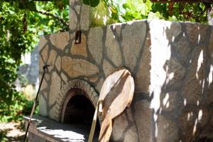 a bird is standing on a stone wall at Vila Zisi Himare in Himare