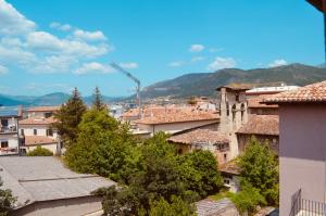 a view of a city with buildings and a crane at La Piazzetta in LʼAquila