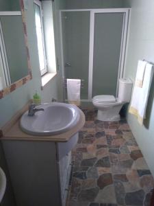 a bathroom with a sink and a toilet at Cantinho Verde in Sertã +20 photos