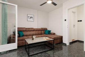 a living room with a brown couch and a table at Sea Breeze in Kotor +10 photos