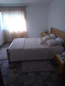 a bedroom with a bed with a dog laying on it at Cantinho Verde in Sertã