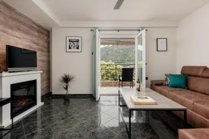 a living room with a couch and a fireplace at Sea Breeze in Kotor