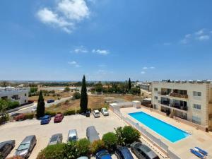 a view of a parking lot with a swimming pool at Stunning views' Apartment with Pool in Paphos