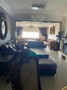 a living room with couches and a chandelier at marina beach mohammedia in Mohammedia