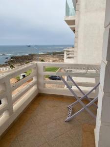 a table on a balcony with a view of the ocean at marina beach mohammedia in Mohammedia