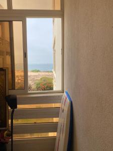 a window in a room with a view of the ocean at marina beach mohammedia in Mohammedia