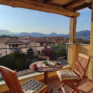a balcony with a table and chairs and a view at Vista Mare Olbia in Olbia