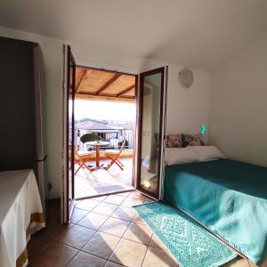 a bedroom with a bed and a sliding glass door at Vista Mare Olbia in Olbia