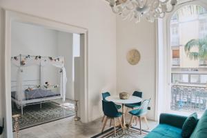 a living room with a bed and a table and chairs at Appartamenti Luxury Greco in Brindisi +99 photos