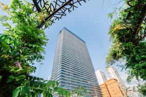 a tall building in the middle of a city at Sunshine Dream Apartments in Batumi