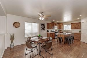 a kitchen with a table and chairs in a room at Stunning 5 Bedroom Rexburg Home in Rexburg