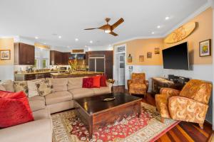 a living room with a couch and a table at 1730 Kaleka 4 Bed Poipu House, Guest House walk to Beach in Koloa