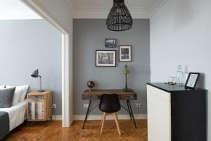 a bedroom with a bed and a desk with a chair at DuMont Lisbon Guesthouse in Lisbon +19 photos