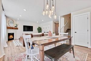 a dining room with a table and chairs and a fireplace at The White Custom Farmhouse 5 bedroom Home in Meridian