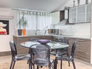 a kitchen with a table and chairs in a kitchen at Athina Sea Villa Close To Athens in Oropós
